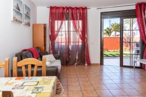 a living room with a couch and a table at El Rincon - No Stress Holidays in El Cotillo