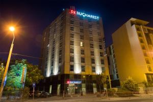 a building with a sign on the top of it at Hotel CH Bucharest in Bucharest