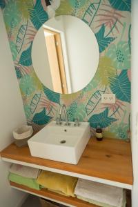 a bathroom with a sink and a mirror at Adelina Hue in San Carlos de Bariloche