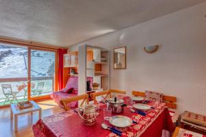 a living room with a table with a red table cloth at Orion 1416 in Villarembert
