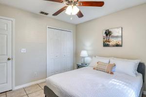 a bedroom with a bed and a ceiling fan at Tiki Nest in Saint Augustine