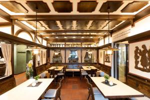 a restaurant with wooden ceilings and tables and chairs at Hotel-Restaurant Weinhaus Grebel in Koblenz