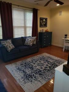 a living room with a blue couch and a rug at Why Not enjoy while away! in Harrisonburg