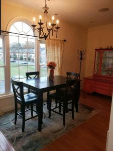 a dining room with a black table and chairs at Why Not enjoy while away! in Harrisonburg
