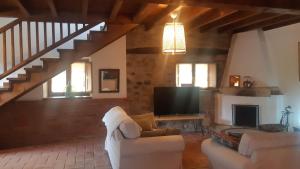 a living room with a couch and a flat screen tv at Casa Liron in Corao