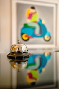 a close up of a bell on top of a mirror at Hotel Bruman Salerno in Salerno