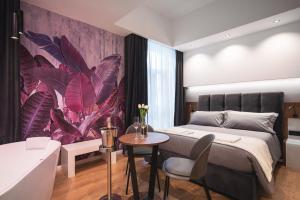 a bedroom with a large bed and a bathroom at Residenze Chamur- Grattacielo in Palermo