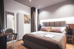 a bedroom with a large bed and a desk at Residenze Chamur- Grattacielo in Palermo