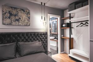 a bedroom with a bed with a black headboard at Residenze Chamur- Grattacielo in Palermo