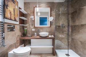 a bathroom with a shower and a toilet and a sink at Residenze Chamur- Grattacielo in Palermo