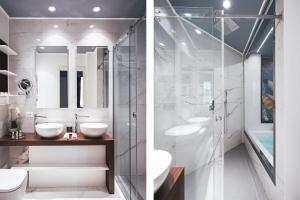 a bathroom with two sinks and a glass shower at Residenze Chamur- Grattacielo in Palermo