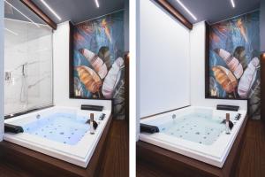 a bathroom with a tub and a painting of feathers at Residenze Chamur- Grattacielo in Palermo