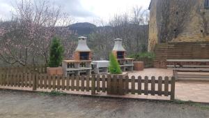 a fence with two large vases on top of it at Casa Liron in Corao