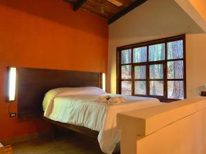 a bedroom with a bed with a stuffed animal on it at Cotan Ecolodge in La Esperanza