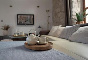 a living room with a couch and two tea cups on a table at Loft in Ismaelli Palace Korcula in Korčula