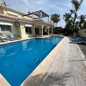 ein Pool vor einem Haus in der Unterkunft Beautiful villa 2 steps from the BEACH in Marbella