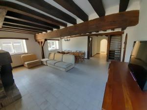 a living room with a couch and a table at Cheverny gîte - Chemin de la levraudière in Cheverny