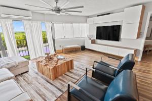 a living room with a couch and a tv at TOWER 2 MASTER SUITEs, 2 KINGS BEDS, MARINA in Key Largo