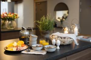 a kitchen counter with bowls of food on a table at Hotel Söder in Stockholm