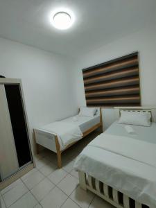 Postel nebo postele na pokoji v ubytování Permai Puteri Homestay Ampang