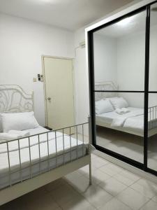 a mirror in a room with a bed and a bed sqor at Permai Puteri Homestay Ampang in Ampang