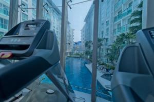 an escalator in a building with a swimming pool at INNER CIRCLE 1 Bed In City Center Residence in Pattaya
