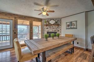 a dining room with a wooden table and a ceiling fan at Lakefront Shell Knob Home with Deck and Gas Grill in Shell Knob