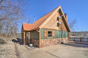 a cabin with a red roof at Lakefront Shell Knob Home with Deck and Gas Grill in Shell Knob