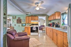 a kitchen with wooden cabinets and a ceiling fan at Mayville Getaway - Walk to Chautauqua Lake! in Mayville