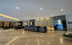 a lobby of a building with a reception desk at Cozy 1BR with balcony at Fame Residences in Manila