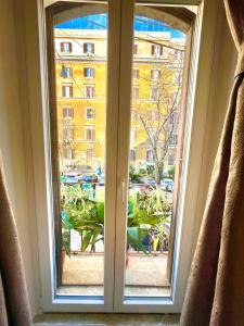 a window with a view of a city at B&B A Home in Rome in Rome