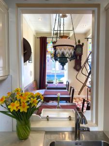 a kitchen with a table with a vase of flowers at BnB 't Ambacht - Boutique Hotel in Hendrik-Ido-Ambacht