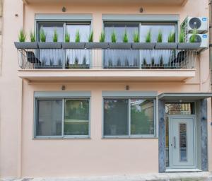 un edificio con un balcón con plantas. en Lepanto Luxury Apartments GF en Nafpaktos