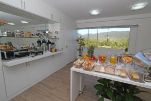 a kitchen with a buffet of food on a table at Hotel Don Zepe in Florianópolis