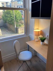 a room with a desk and a chair and a window at 'Bloomfield' at stayBOOM in Lancaster