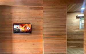 two images of a wall with wood paneling at Norbu Thungkar Homestay in Darjeeling