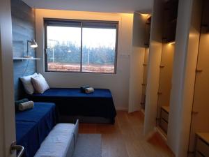 a small room with two beds and a window at Prestige & Nature Apartment in Laguna Village in Quarteira +34 photos