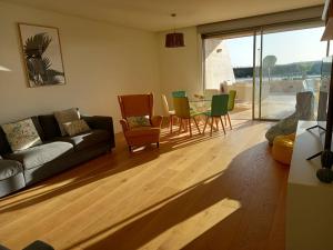 a living room with a couch and a table and chairs at Prestige & Nature Apartment in Laguna Village in Quarteira