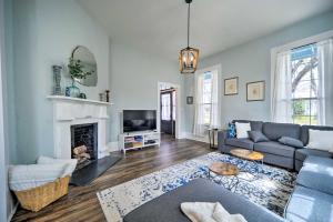 a living room with a couch and a fireplace at Spacious Abode, Walk to Texas Heroes Square! in Gonzales