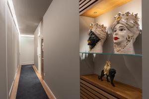 a hallway with masks on display in a house at Residenze Chamur- Grattacielo in Palermo