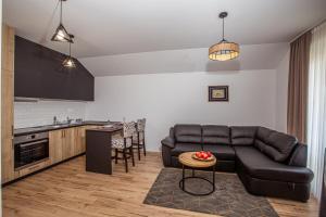 a living room with a couch and a kitchen at Rest Apartments in Nikšić
