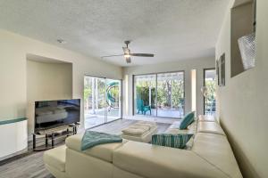 a living room with a couch and a tv at Tropical Waterfront Home Central Location! in Clearwater Beach