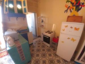 a kitchen with a refrigerator and a stove at Triesti Home in Victoria
