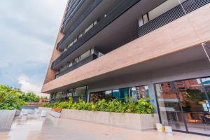 a building with plants in front of it at Luxury Suite in El Poblado Co-Work, Gym, Fast WiFi in Medellín