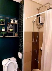 a bathroom with a toilet and a shower at SM Spring Residences Tower 2 Condominium Bicutan Parañaque Cozy Condo in Manila