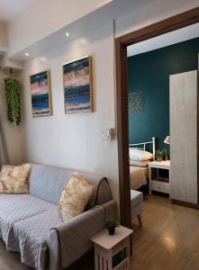 マニラにあるSM Spring Residences Tower 2 Condominium Bicutan Parañaque Cozy Condoのリビングルーム(ソファ付)、ベッドルーム1室が備わります。