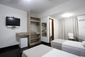 Cama ou camas em um quarto em Savassi Hotel