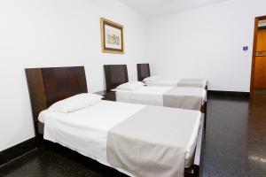 Cama ou camas em um quarto em Savassi Hotel