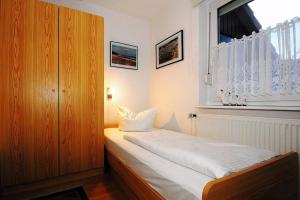 een slaapkamer met een wit bed en een raam bij Urlauberdorf Urlauberdorf 49d in Boltenhagen