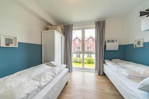 Voodi või voodid majutusasutuse NordseeResort Friesland NordseeResort Friesland 30 toas